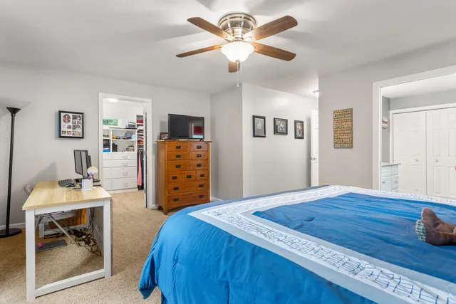 a bedroom with a bed and a table in it