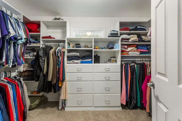 a view of walk in closet with clothes