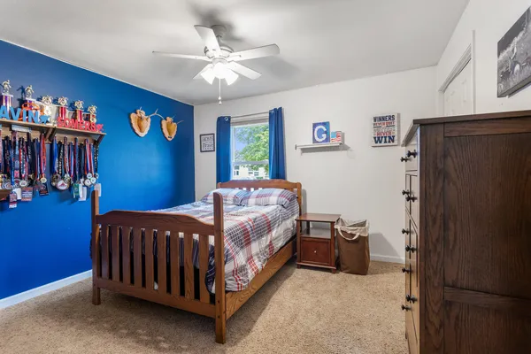 a bed sitting in a bedroom next to a window