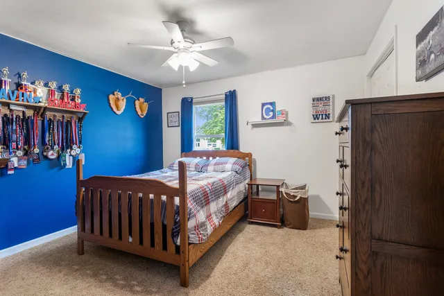 a bed sitting in a bedroom next to a window