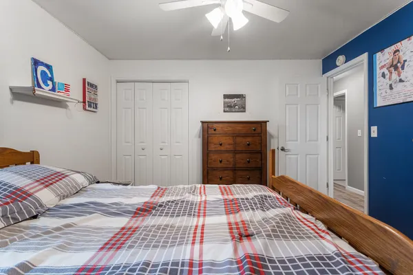 a bedroom with a bed and a mirror