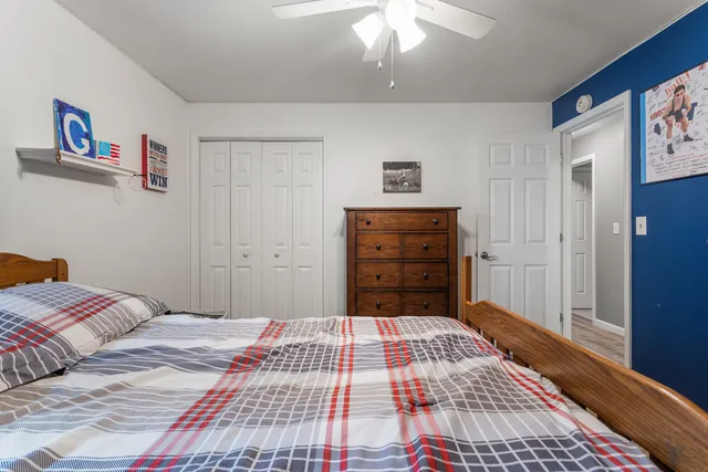 a bedroom with a bed and a mirror