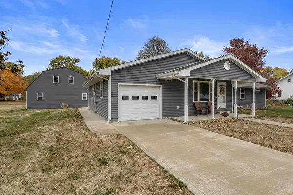 a front view of a house with a garden