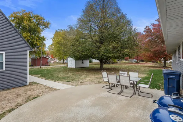 a view of a backyard with sitting area