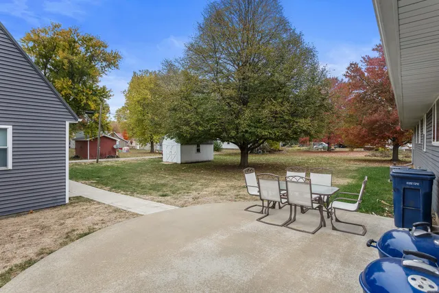 a view of a backyard with sitting area