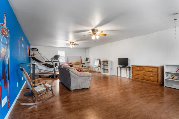 a living room with furniture kitchen view and a chandelier