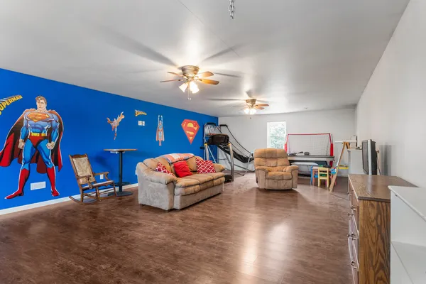a living room with furniture gym equipment and a flat screen tv