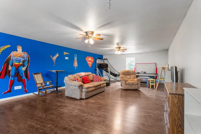 a living room with furniture gym equipment and a flat screen tv