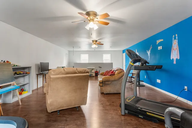 a living room with furniture and a chandelier