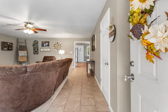 a living room with furniture and a chandelier