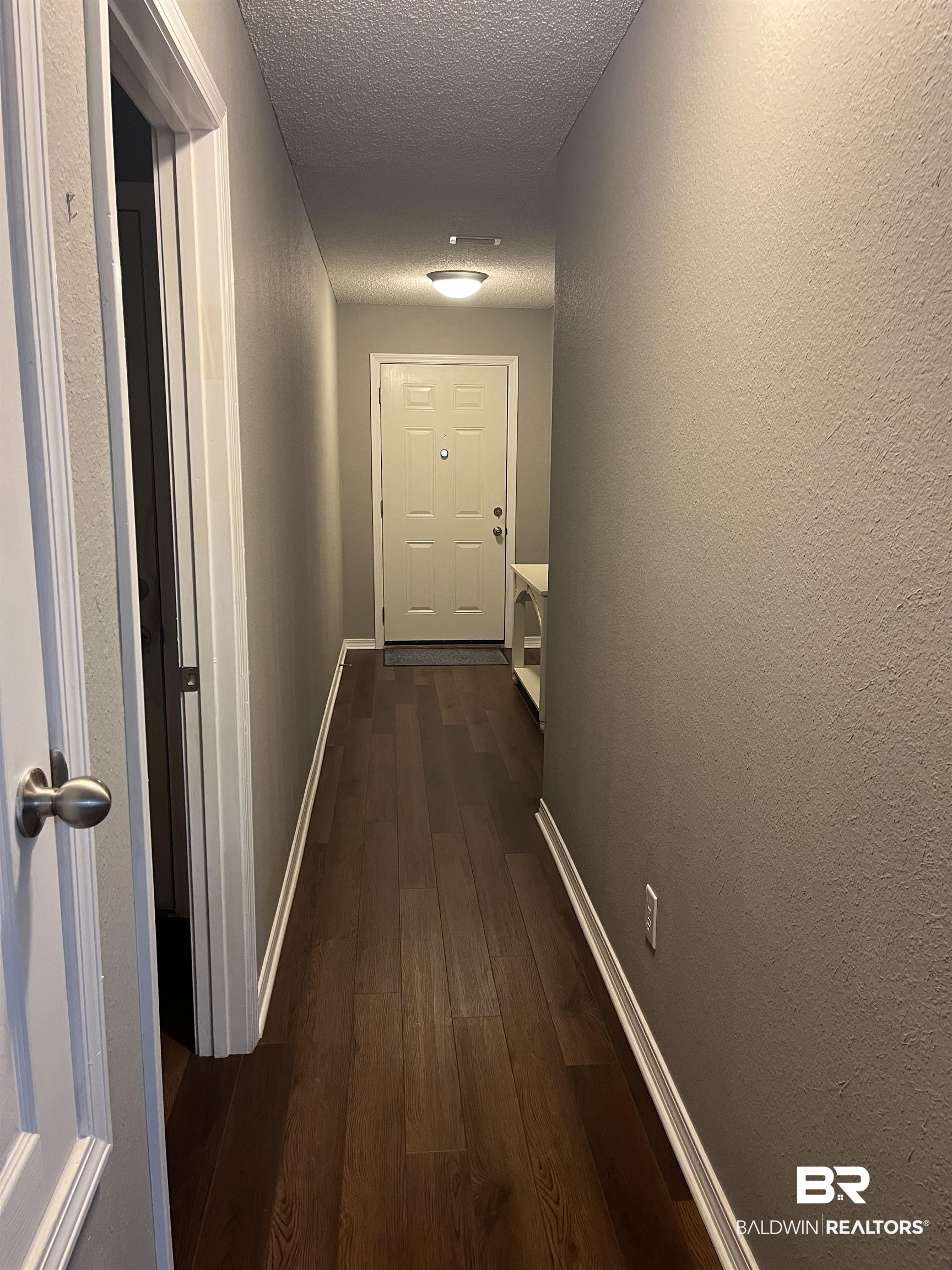 309 Cluster Street Foley, AL 36535 - Photo 20 of 38 Entryway featuring wood-finish flooring, neutral wall paint, and white trim
