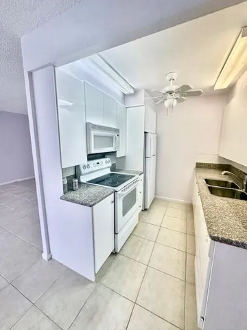 a kitchen with stainless steel appliances granite countertop a sink and a stove