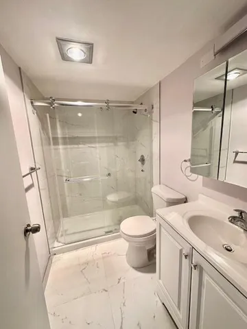 a bathroom with a sink toilet and shower