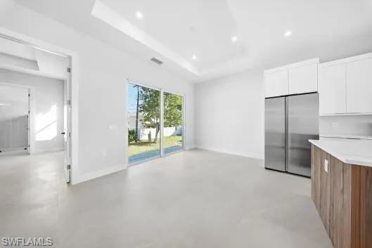 a view of an empty room with a kitchen