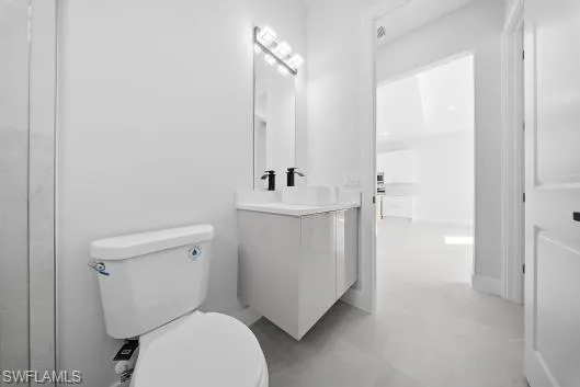 a white toilet sitting next to a bathroom sink