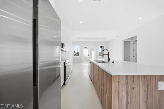 a kitchen with refrigerator cabinets and double vanity
