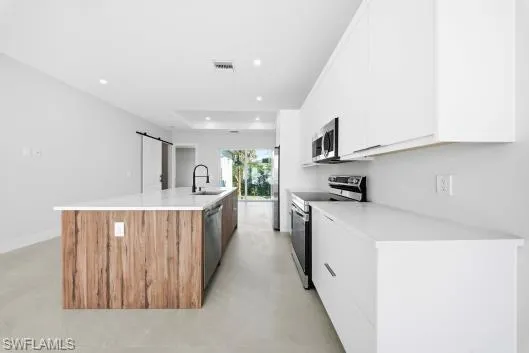 a kitchen with a refrigerator a sink and a stove