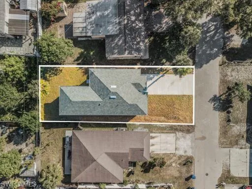 an aerial view of a house with a mountain