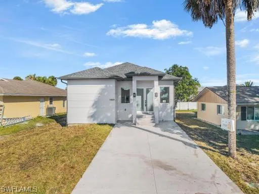 a front view of a house with a yard and garage