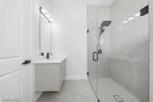 a bathroom with a shower sink and mirror
