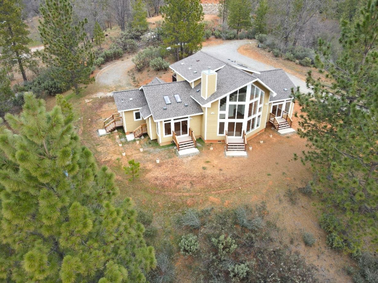 an aerial view of residential houses with yard