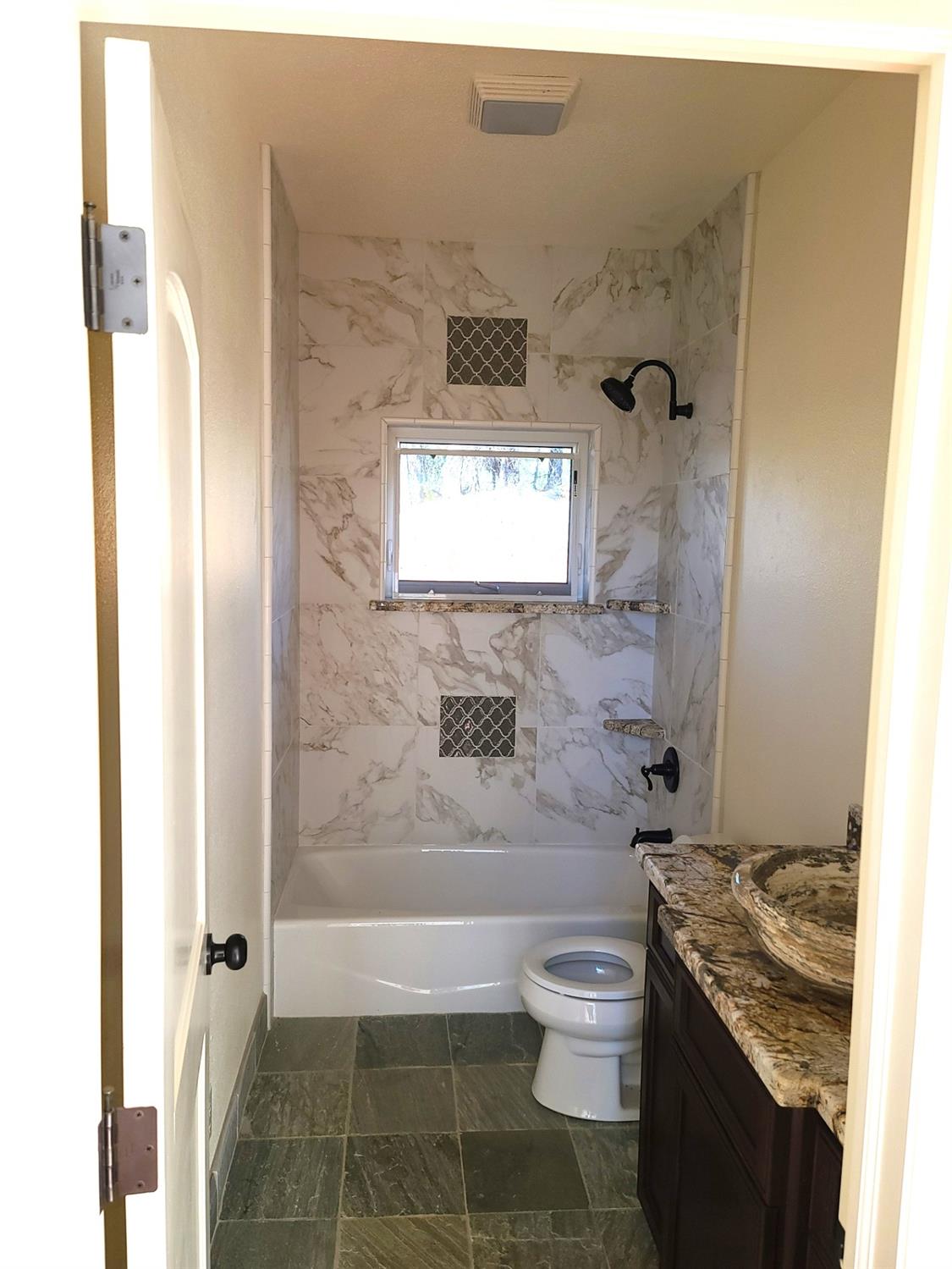 2805 Mason Road Rail Road Flat, CA 95248 - Photo 50 of 75 a bathroom with a granite countertop toilet a sink and bathtub