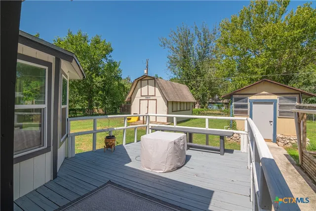 a view of a house with a yard and sitting area