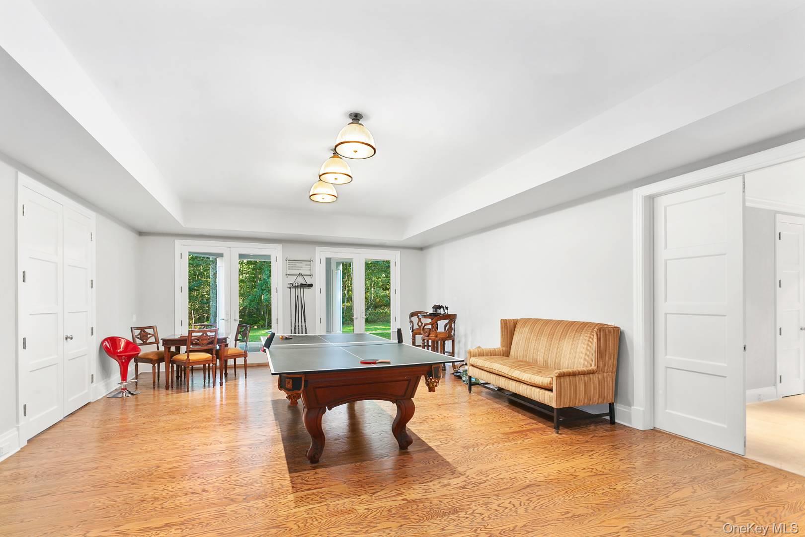 1477 Deerfield Road Water Mill, NY 11976 - Photo 6 of 17 Game room featuring light wood-type flooring and a tray ceiling