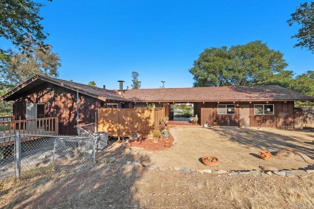 16522 Orchard Bend Road Poway, CA 92064 - Photo 22 of 26 a view of large house with wooden fence