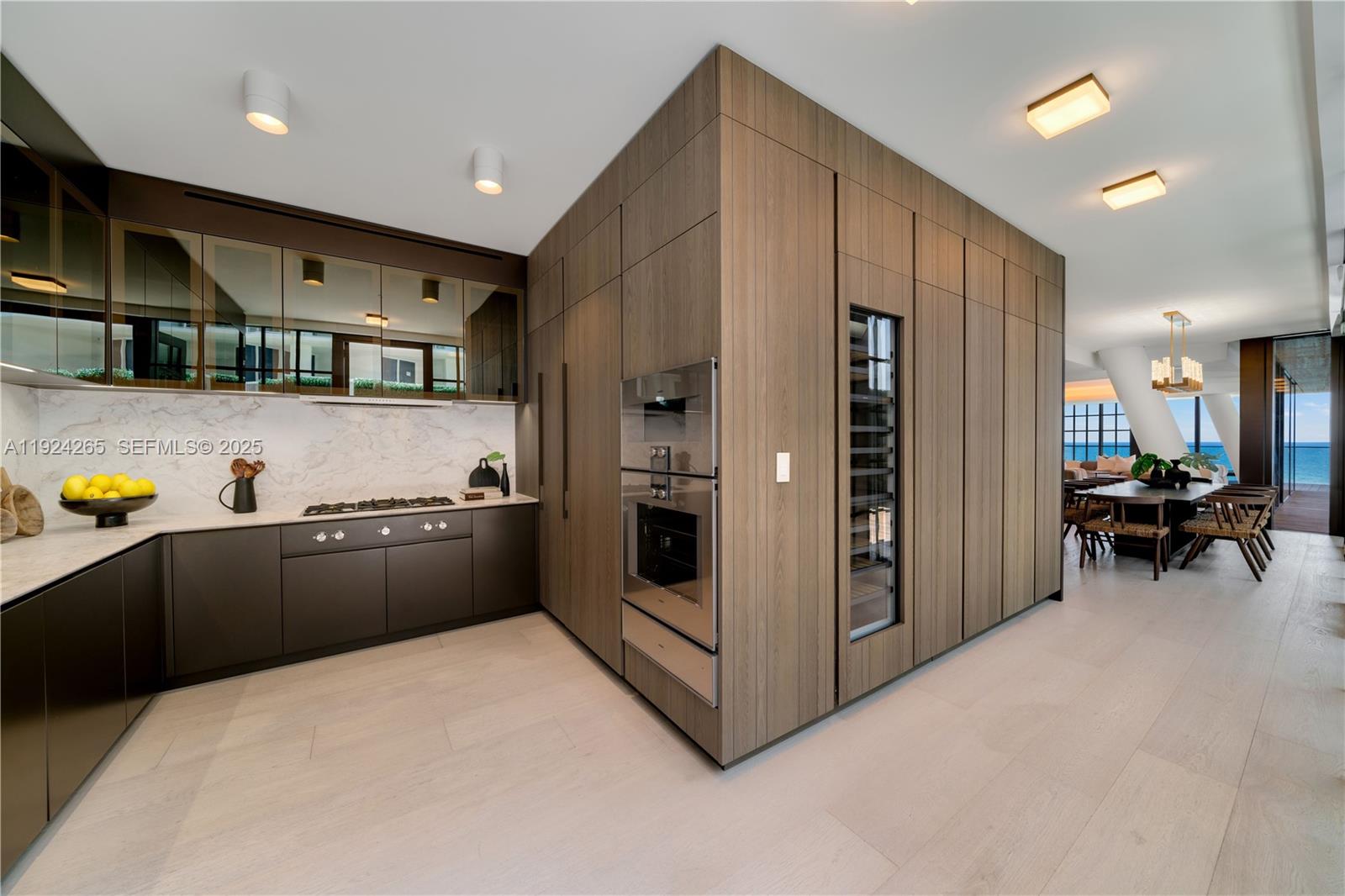 8955 Collins Avenue, Unit 702 Surfside, FL 33154 - Photo 18 of 56 a kitchen with stainless steel appliances kitchen island granite countertop a refrigerator and a sink