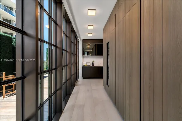 a bedroom with furniture and large windows