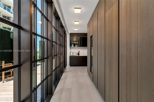 a bedroom with furniture and large windows