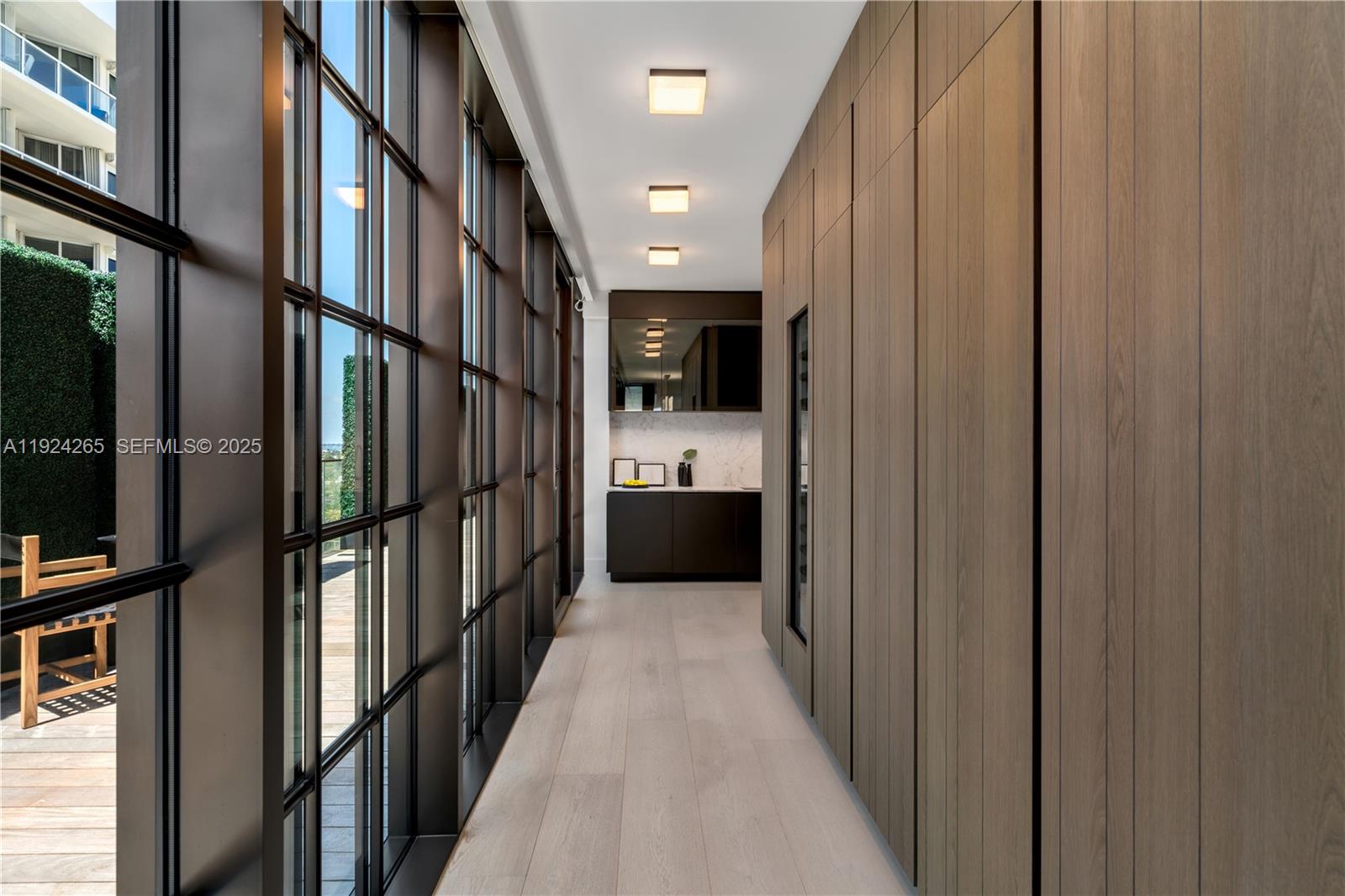 8955 Collins Avenue, Unit 702 Surfside, FL 33154 - Photo 20 of 56 a view of hallway with wooden floor and stairs