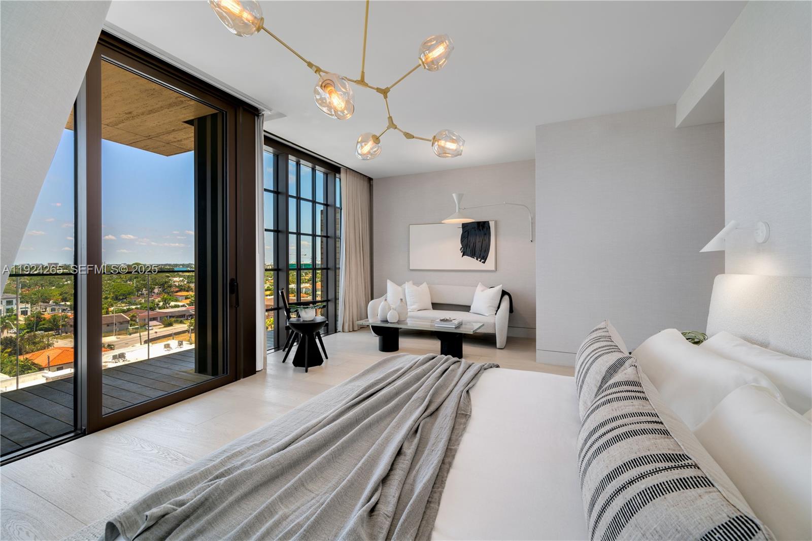 8955 Collins Avenue, Unit 702 Surfside, FL 33154 - Photo 26 of 56 a bed room with a bed and a chandelier