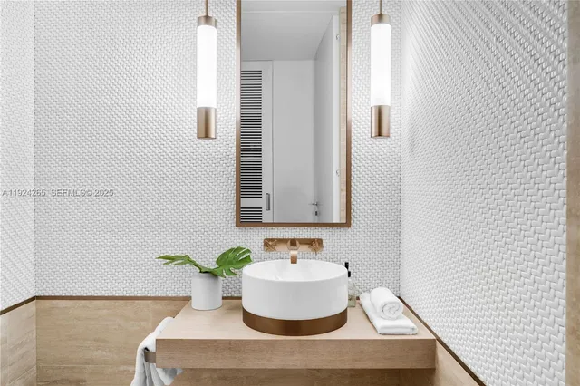 a bathroom with a tub shower and sink