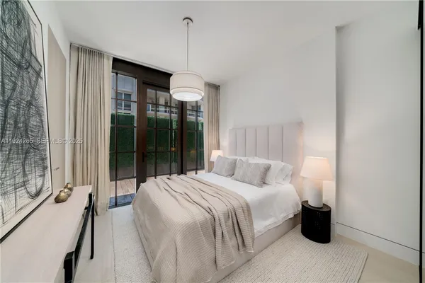 a bedroom with a bed and a potted plant