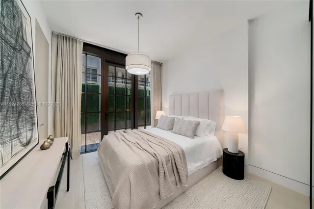 a bedroom with a bed and a potted plant