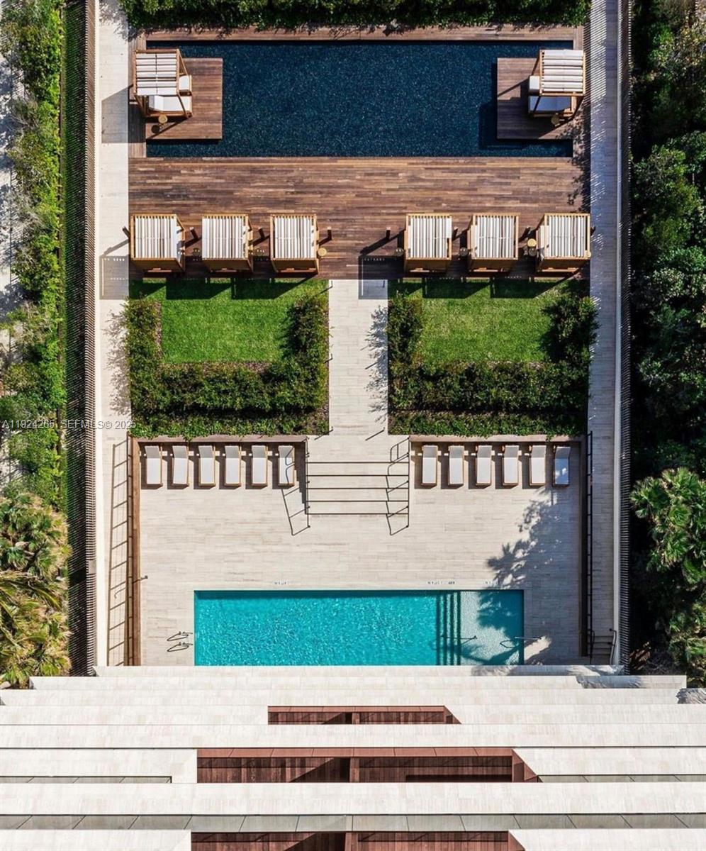 8955 Collins Avenue, Unit 702 Surfside, FL 33154 - Photo 53 of 56 a view of a brick house with a small yard