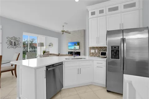 a kitchen with a sink microwave and refrigerator