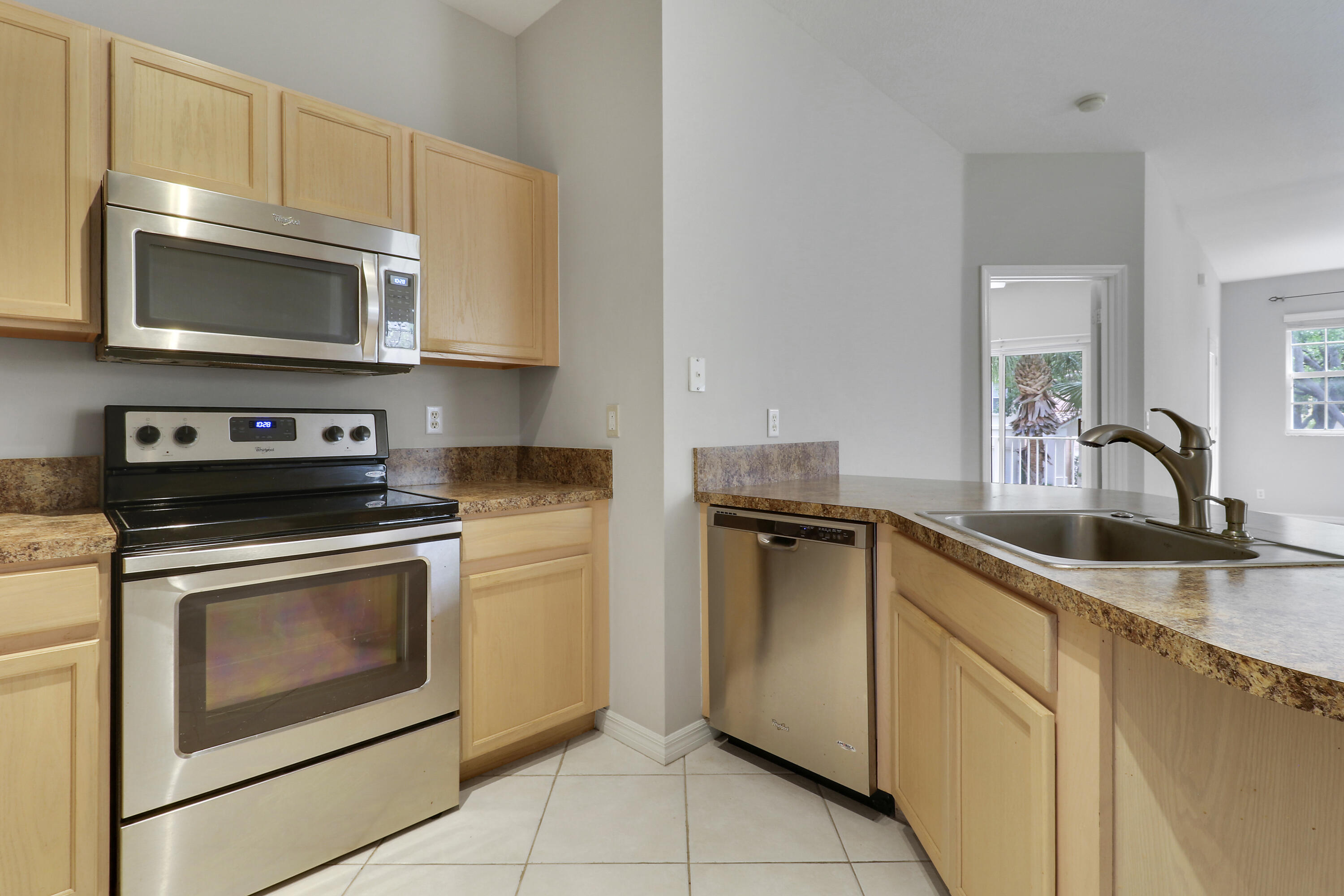 104 Lighthouse Circle, Unit H2 Tequesta, FL 33469 - Photo 12 of 45 a kitchen with cabinets stainless steel appliances and a sink