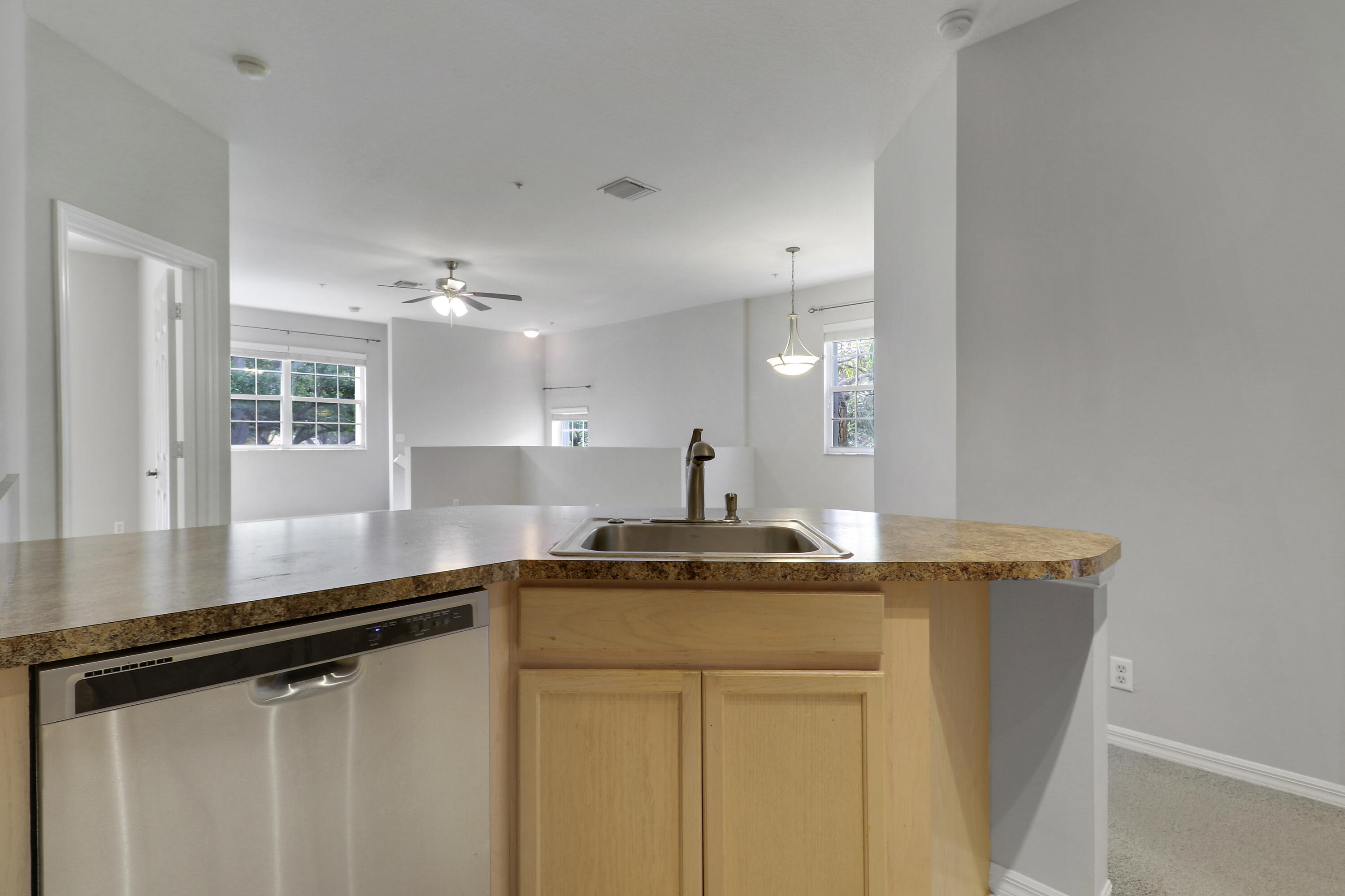 104 Lighthouse Circle, Unit H2 Tequesta, FL 33469 - Photo 13 of 45 a kitchen with a sink and a refrigerator