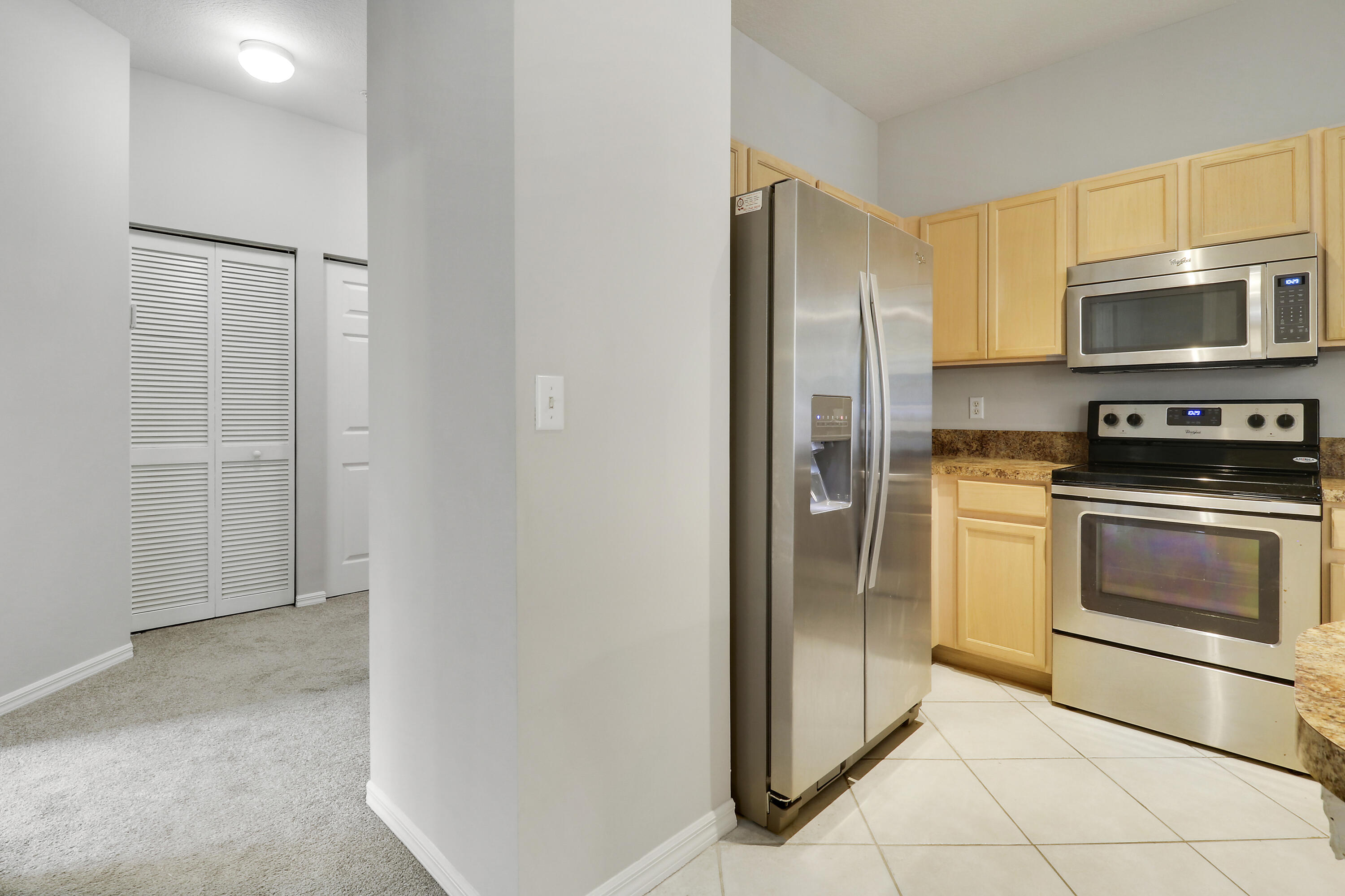 104 Lighthouse Circle, Unit H2 Tequesta, FL 33469 - Photo 15 of 45 a kitchen with stainless steel appliances granite countertop a refrigerator a stove and a sink
