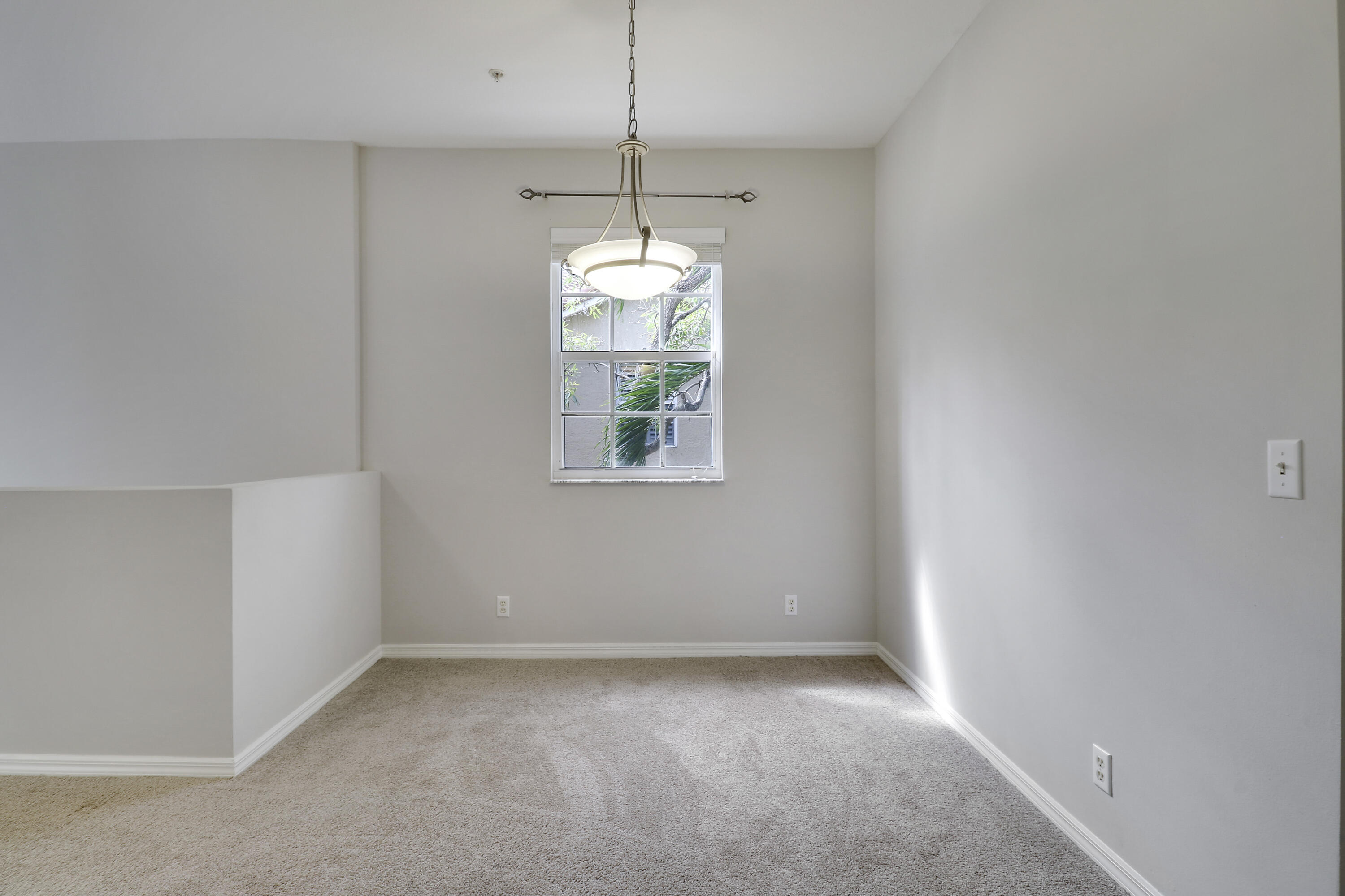 104 Lighthouse Circle, Unit H2 Tequesta, FL 33469 - Photo 16 of 45 a view of a room with window and chandelier fan