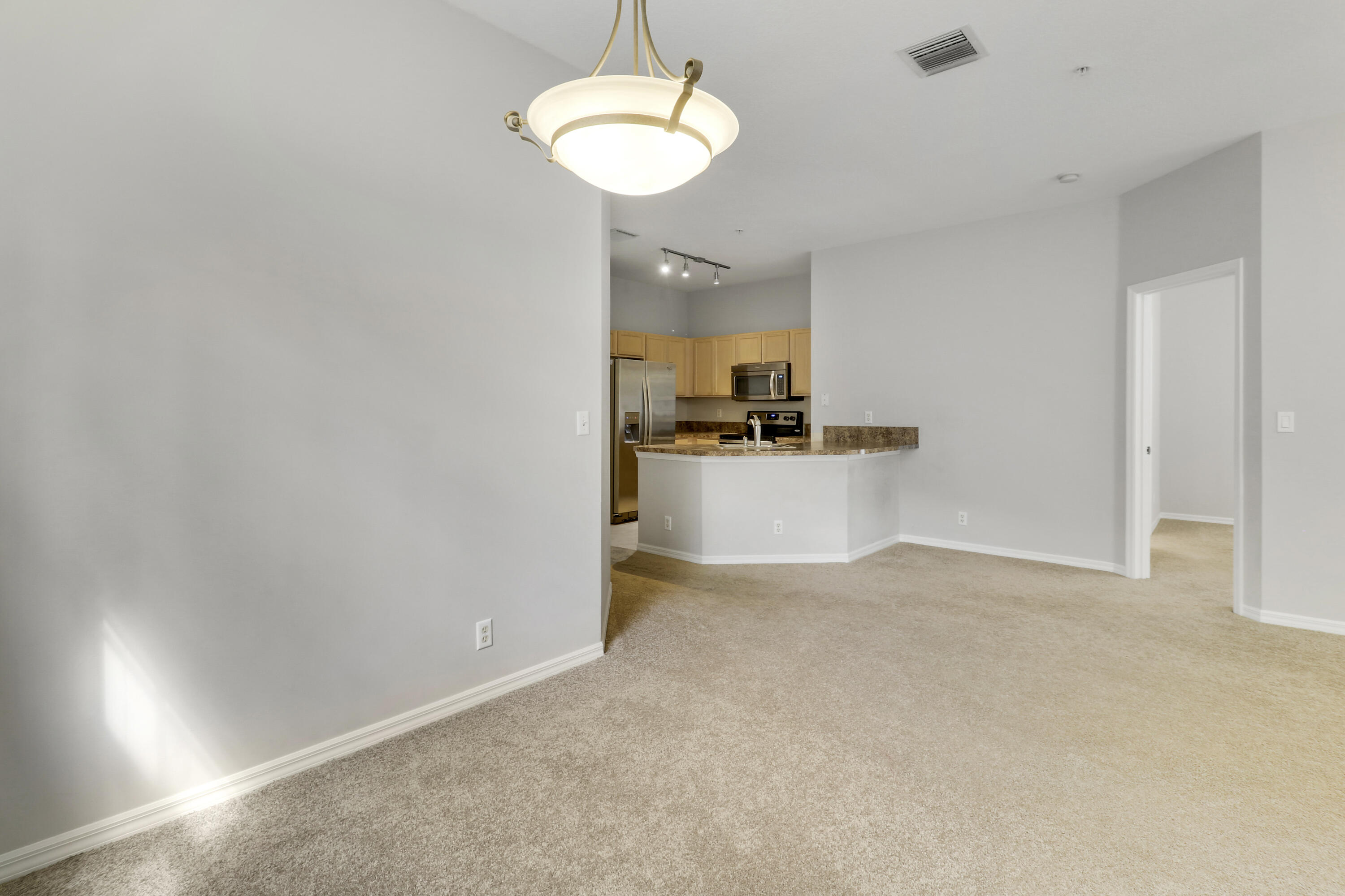 104 Lighthouse Circle, Unit H2 Tequesta, FL 33469 - Photo 17 of 45 a view of a kitchen with a sink and a refrigerator