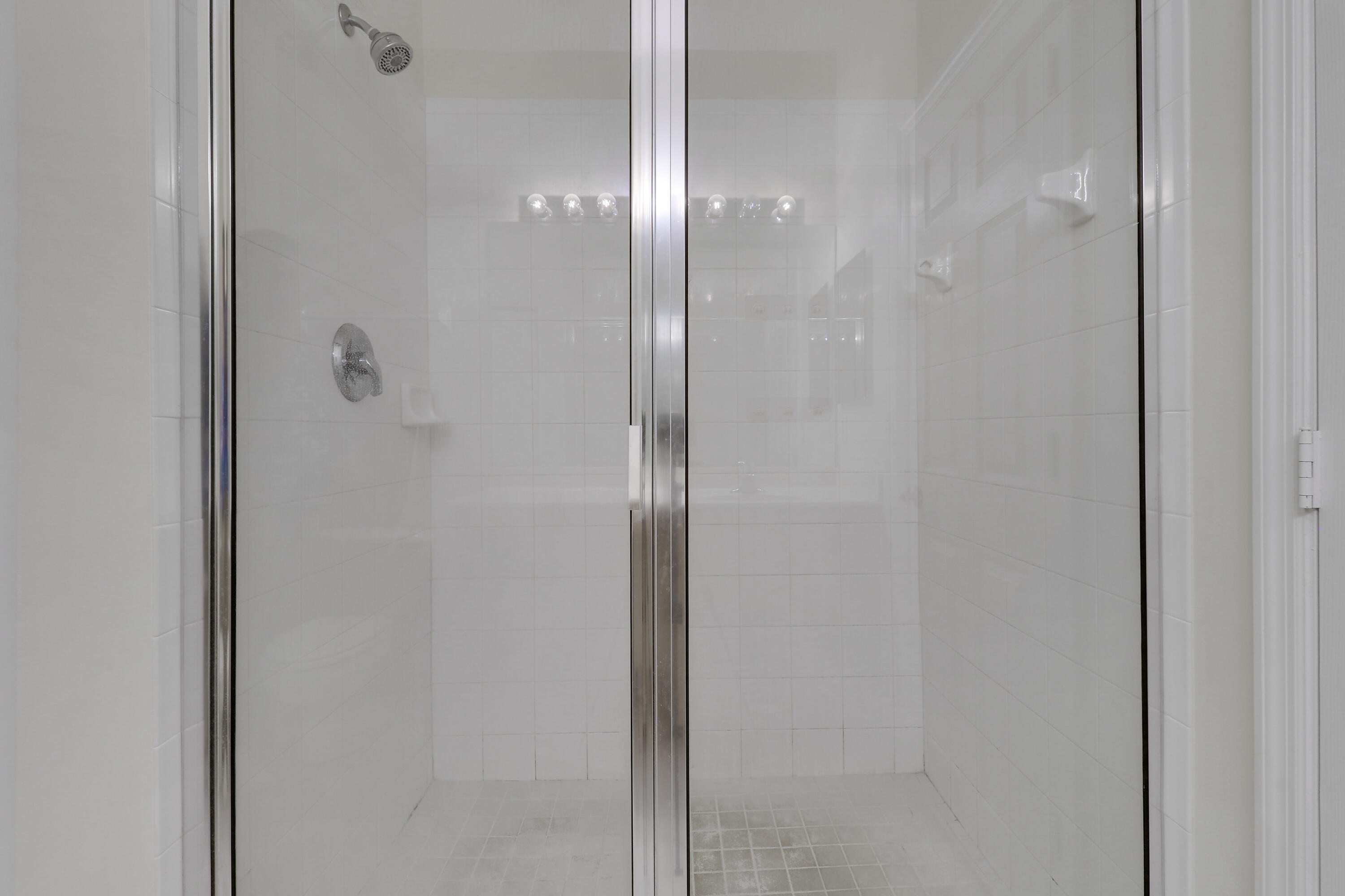 104 Lighthouse Circle, Unit H2 Tequesta, FL 33469 - Photo 22 of 45 a bathroom with a glass shower door
