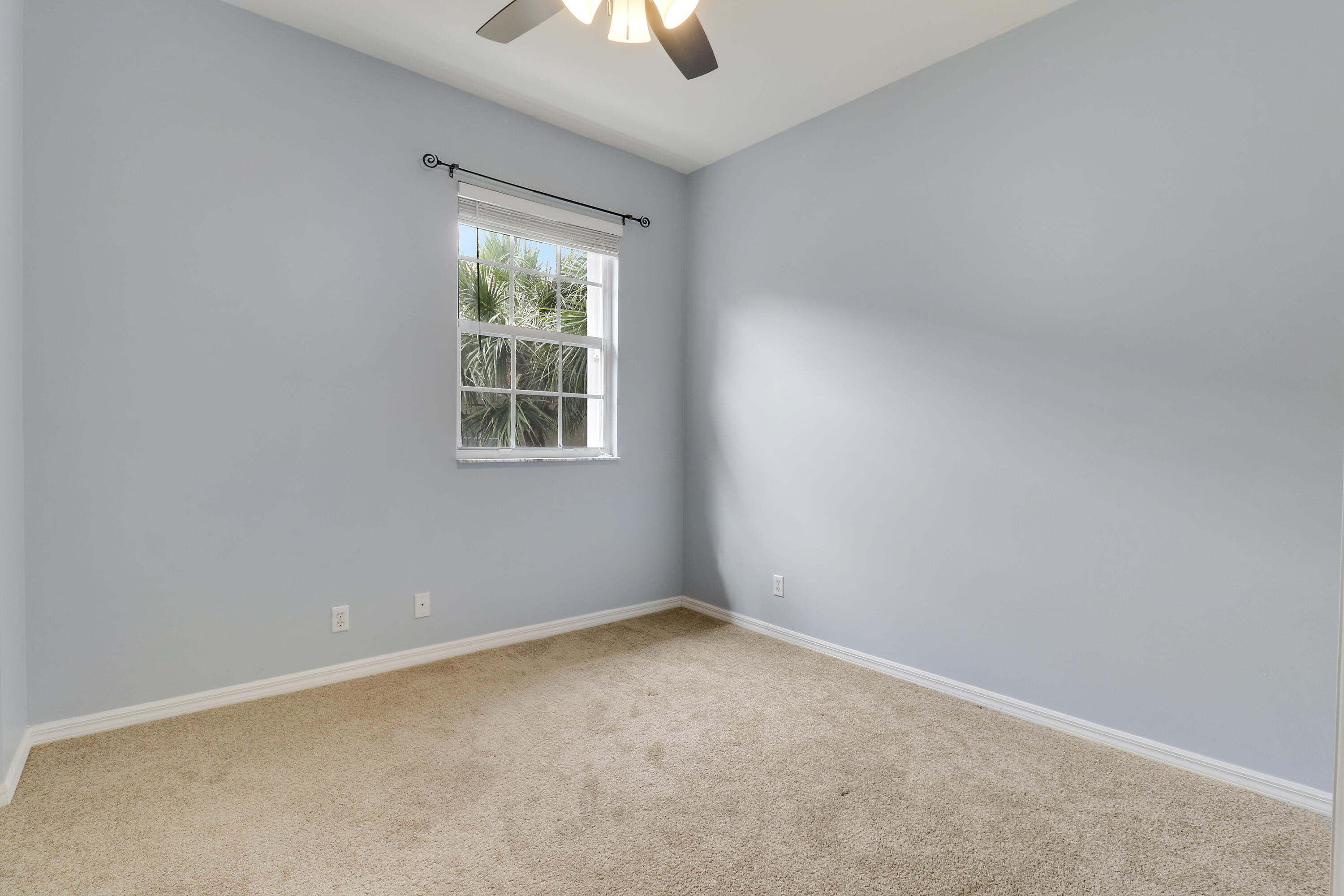 104 Lighthouse Circle, Unit H2 Tequesta, FL 33469 - Photo 23 of 45 an empty room with a window and ceiling fan