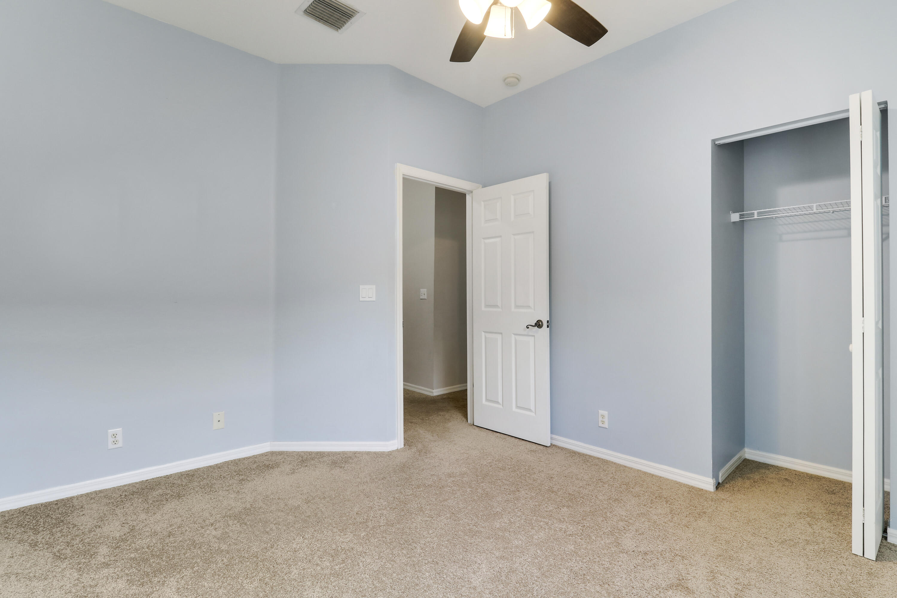104 Lighthouse Circle, Unit H2 Tequesta, FL 33469 - Photo 24 of 45 an empty room with chandelier fan