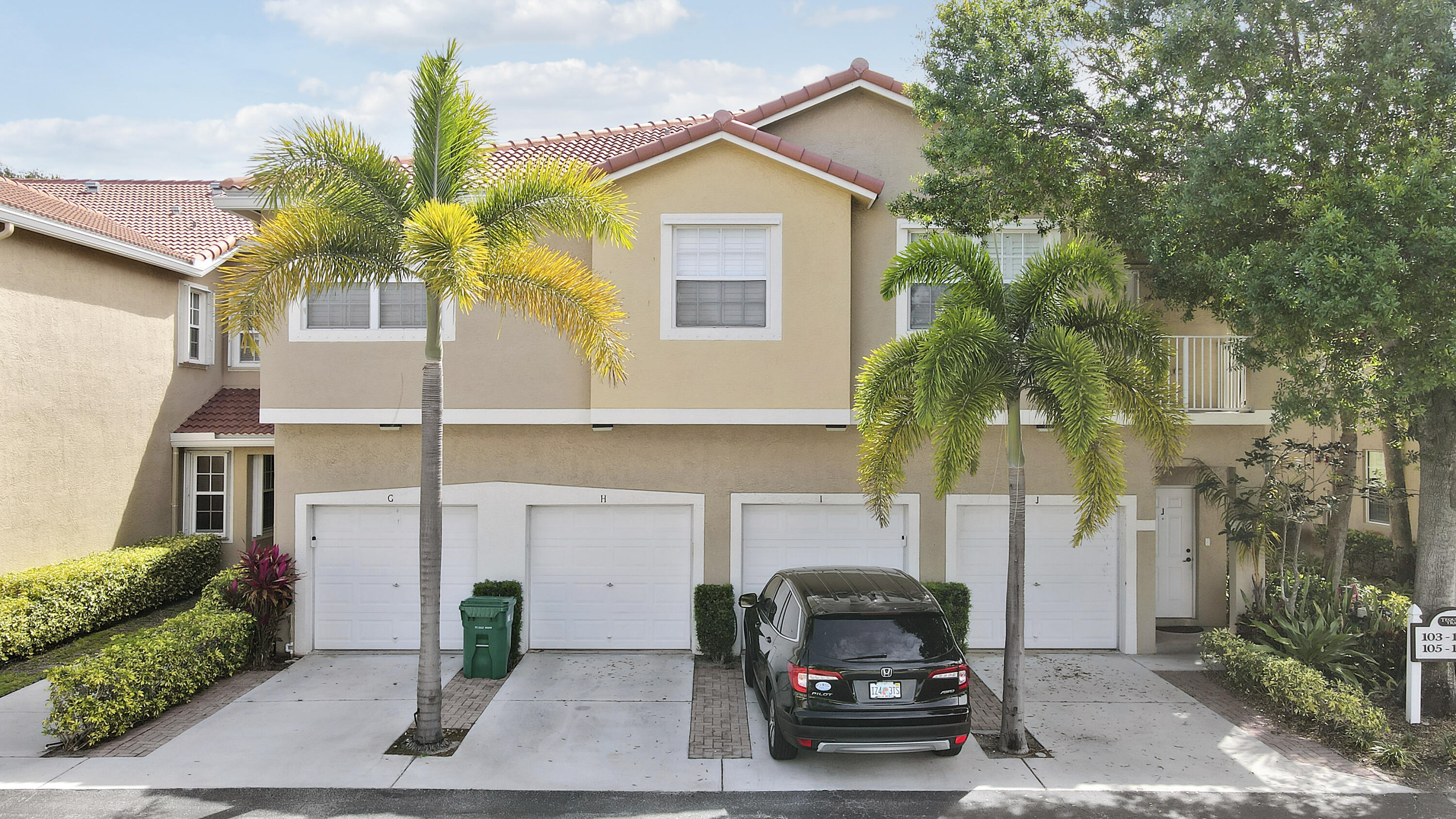 104 Lighthouse Circle, Unit H2 Tequesta, FL 33469 - Photo 33 of 45 a car parked in front of a house
