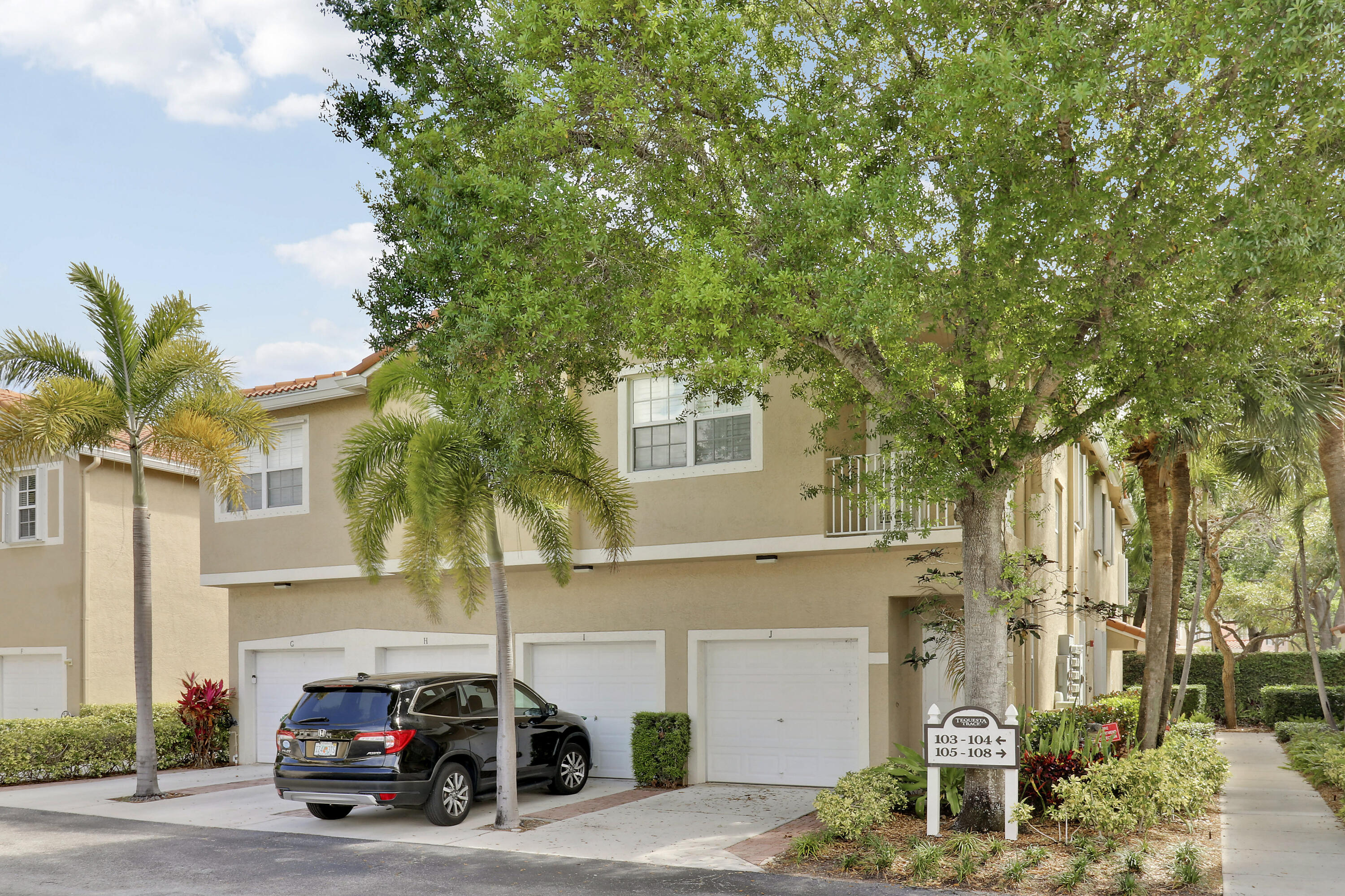 104 Lighthouse Circle, Unit H2 Tequesta, FL 33469 - Photo 34 of 45 a car parked in front of a house