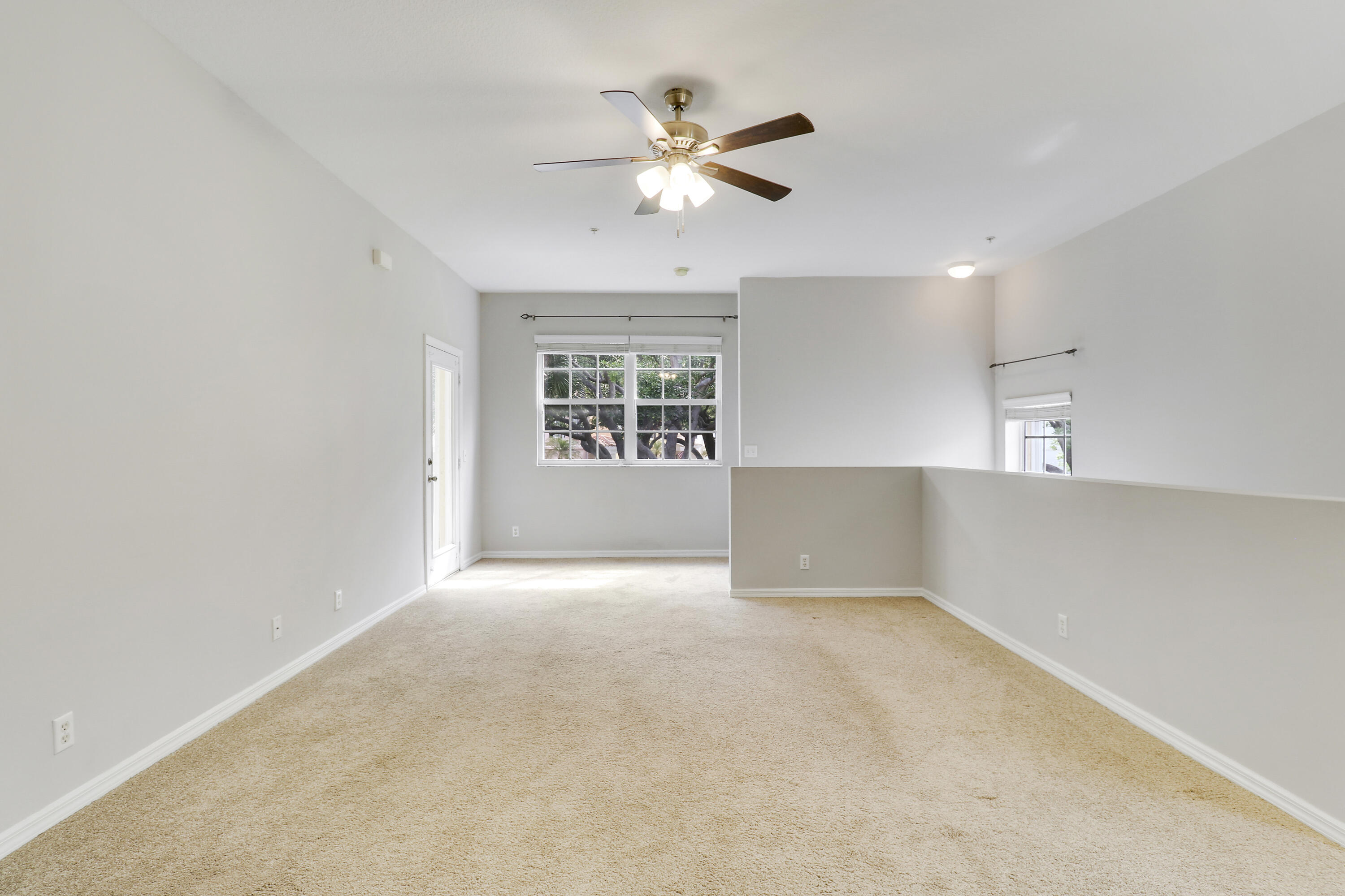 104 Lighthouse Circle, Unit H2 Tequesta, FL 33469 - Photo 6 of 45 an empty room with a ceiling fan and window